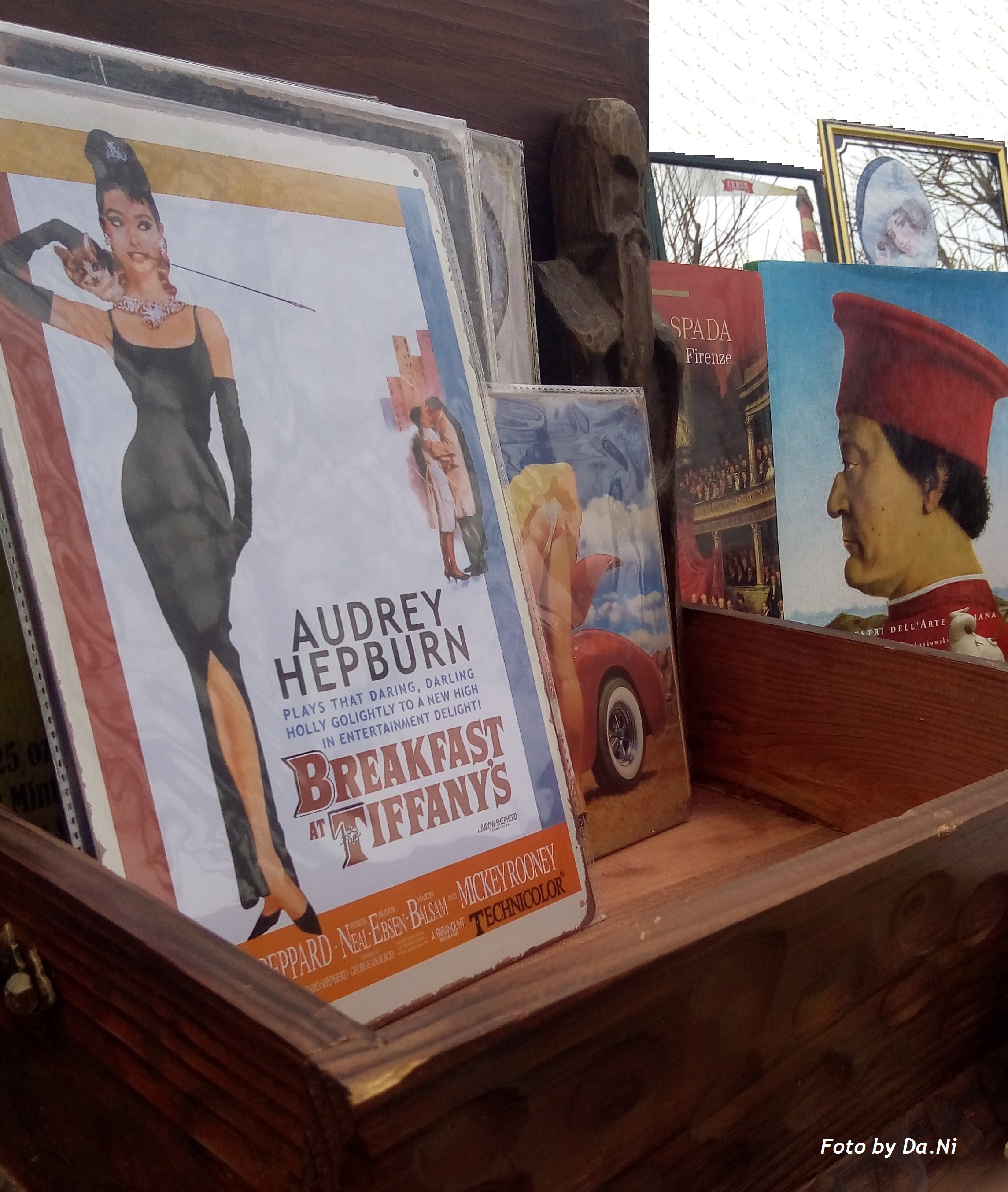 Immagine di locandina raffigurante l'attrice Audrey Hepburn, e sullo sfondo alcuni libri
