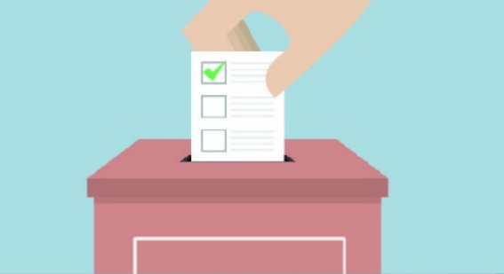 Un'urna elettorale con una mano che inserisce al suo interno una scheda elettorale